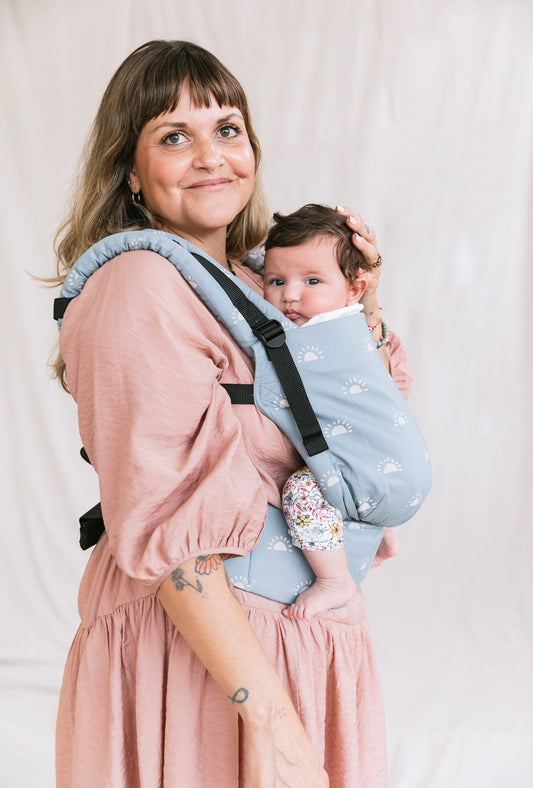 image of woman wearing a baby carrier