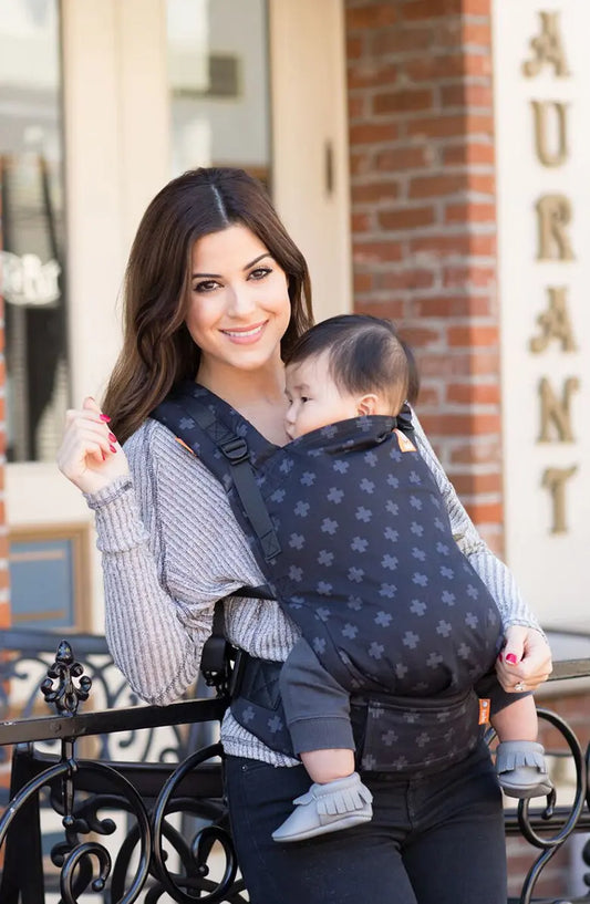 woman wearing baby in carrier