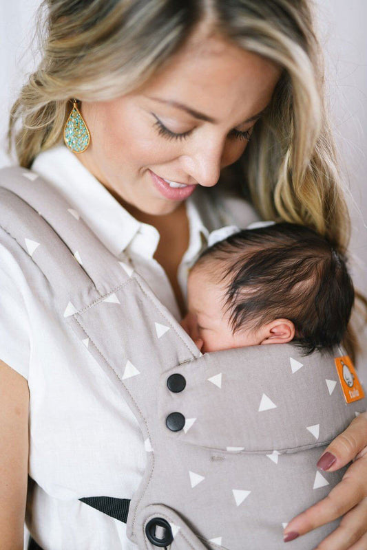 image of woman holding sleeping baby