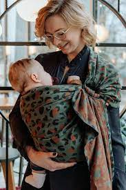 image of woman wearing baby in a sling