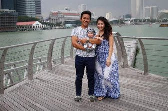 image of family outside by water