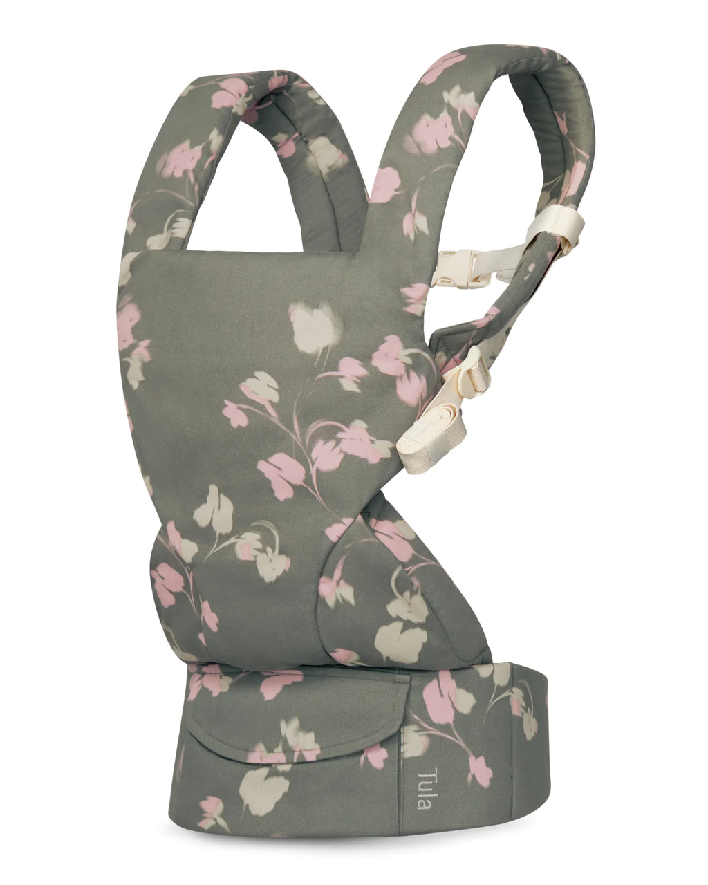 A cotton baby carrier in a muted gray-green fabric with a pink and white floral pattern, featuring cream-colored plastic buckle closures. The brand name 'Tuia' is visible on a small fabric tag on the bottom waist belt.