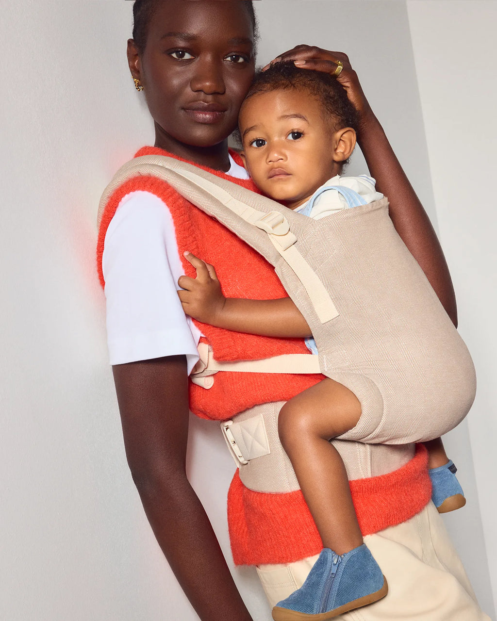 A woman and a young child wearing a the tula original baby carrier in Sand. 
