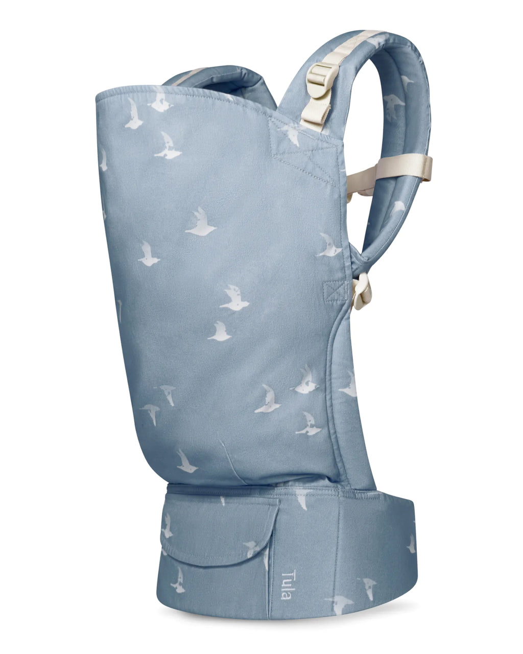 A toddler carrier in dusty blue with a white bird pattern, featuring adjustable shoulder straps and a front pocket, shown on a plain white background.