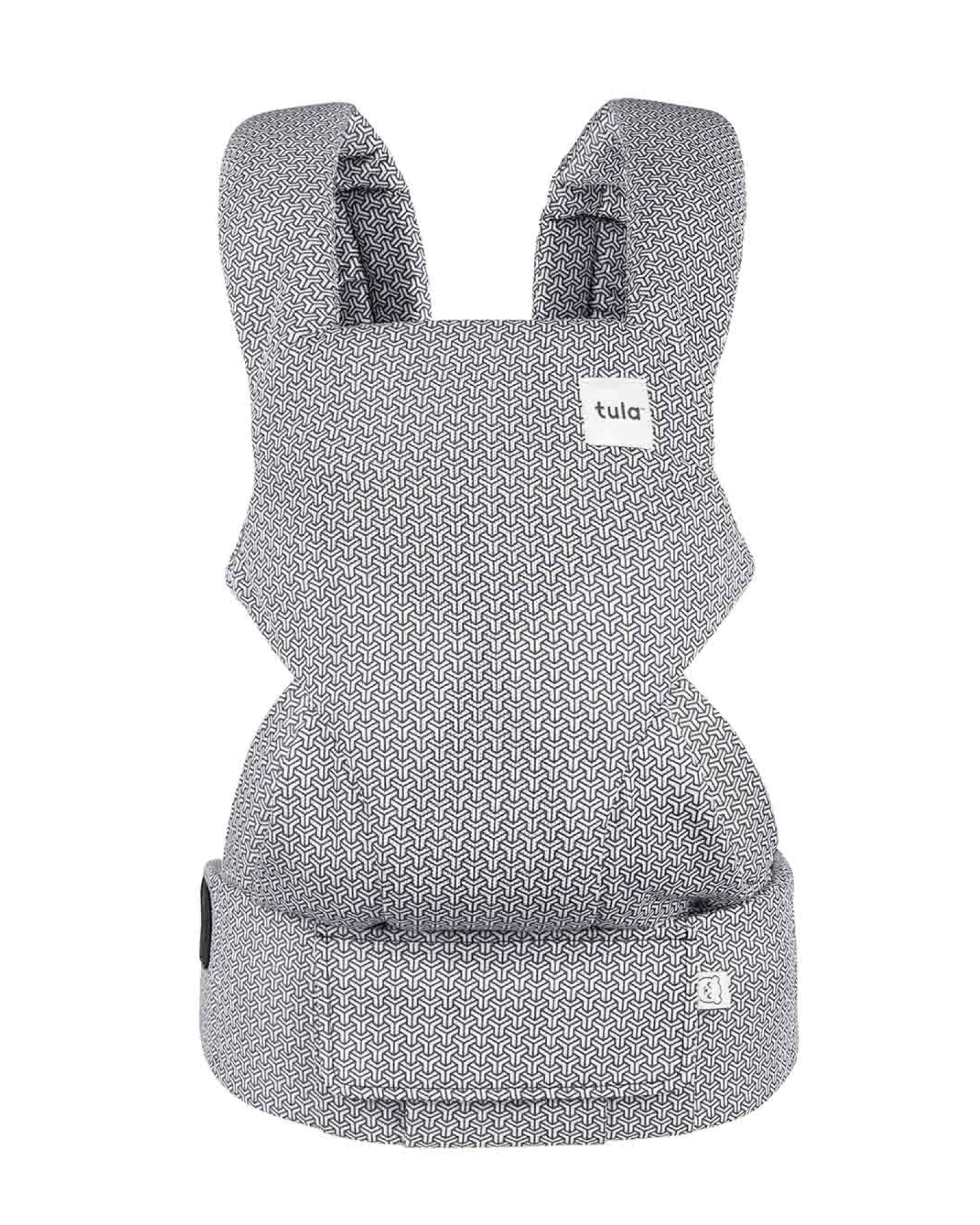 A baby carrier with a light gray and white geometric pattern, featuring a small white 'tula' brand label on the upper right side.