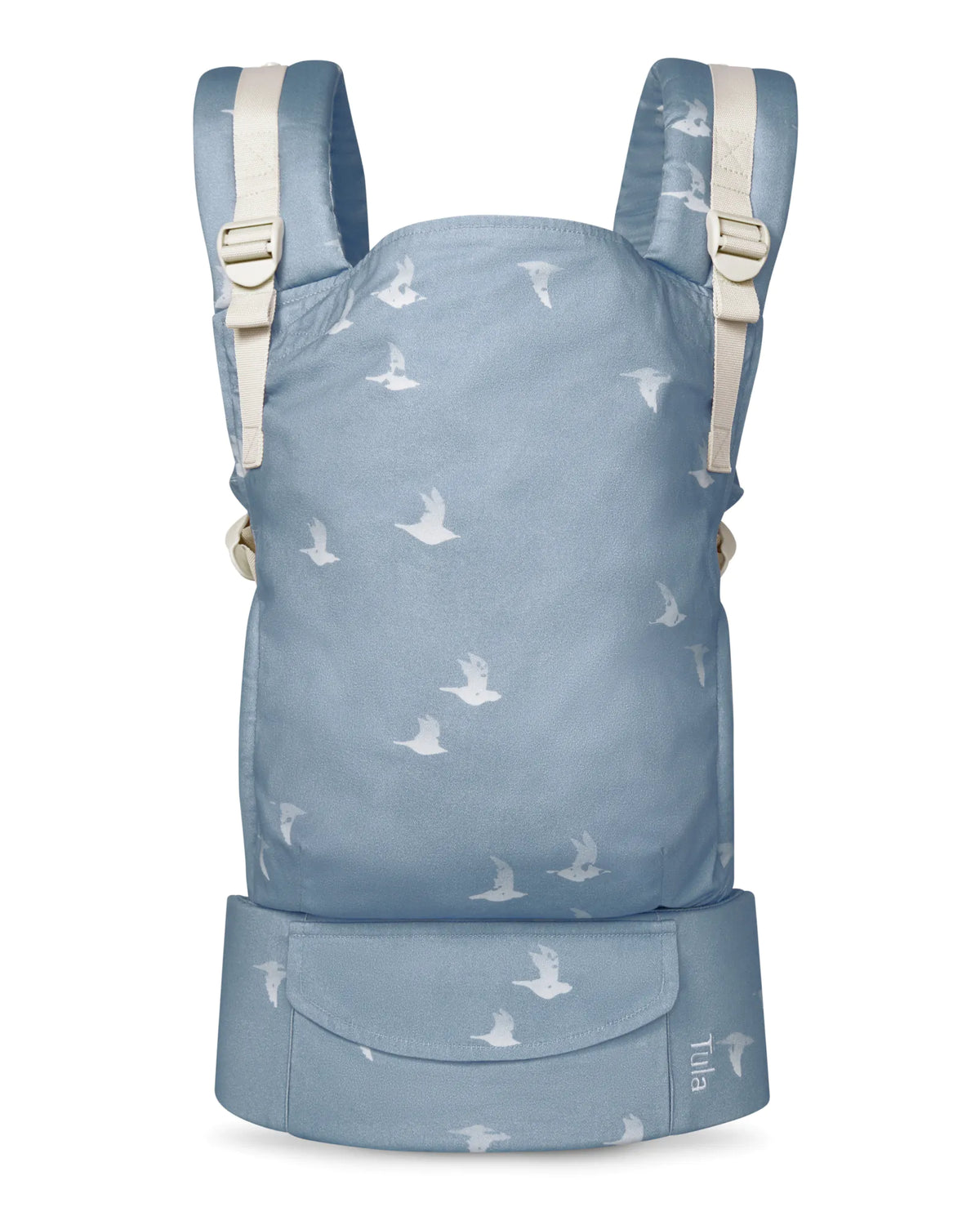 A cotton baby carrier in dusty blue with a white bird pattern, featuring cream-colored shoulder straps and buckles, shown against a plain white background.