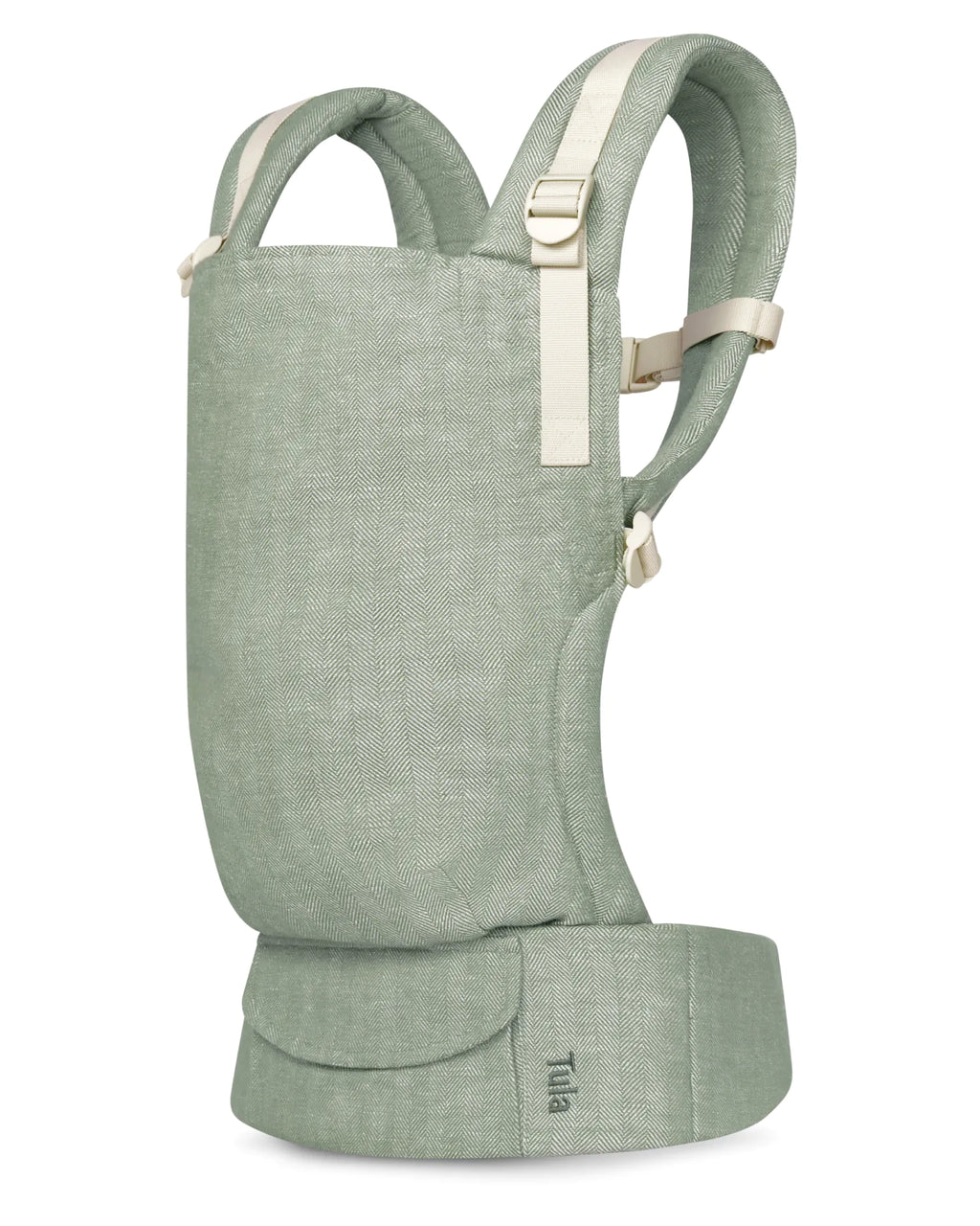 A sage green linen baby carrier with cream-colored straps and buckles, shown from a front three-quarter angle on a solid white background.