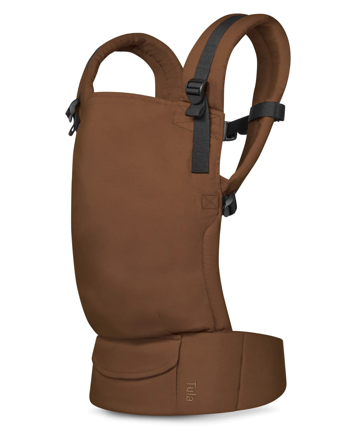 A brown linen baby carrier shown from the side against a plain white background, featuring black adjustable shoulder straps and a small 'Tula' brand label near the bottom front pocket.