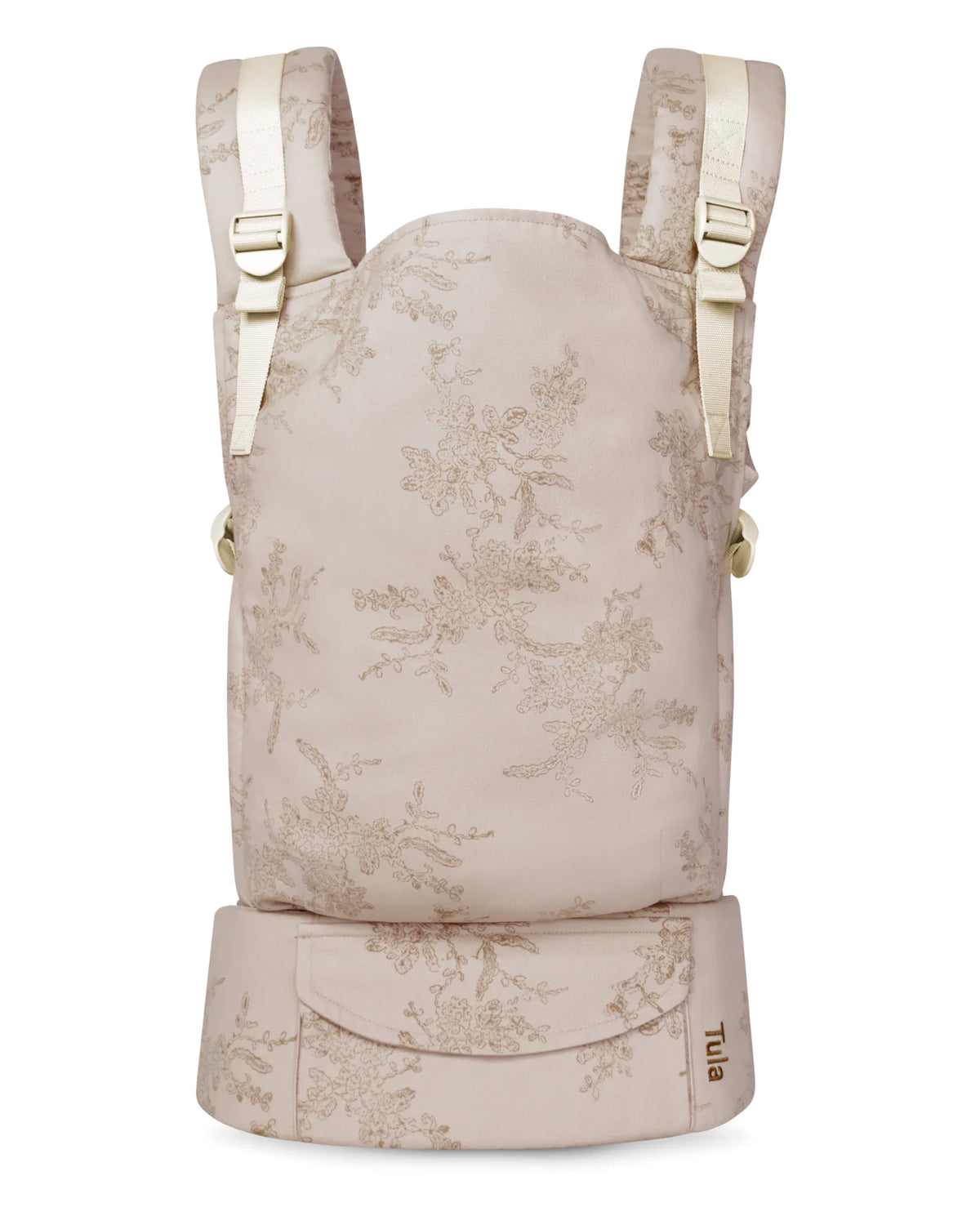 A cotton original baby carrier in a light beige fabric with a delicate floral toile pattern, featuring cream-colored shoulder straps and side buckles, and a matching waist belt at the bottom.