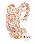 The Tula Original baby carrier with a floral pattern in pink, orange, and yellow on a cream background, featuring a mesh front panel.