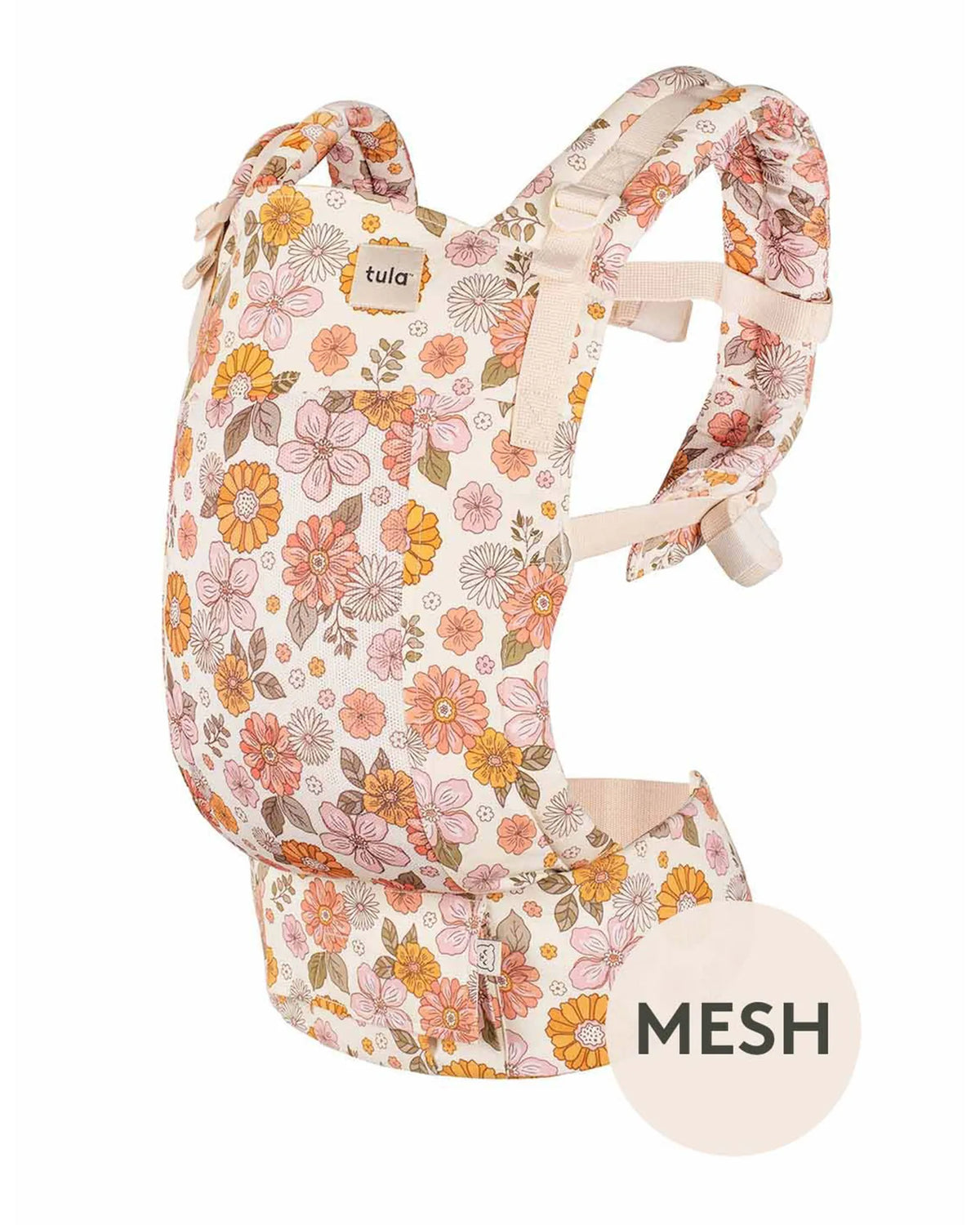 The Tula Original baby carrier with a floral pattern in pink, orange, and yellow on a cream background, featuring a mesh front panel.