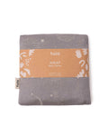 A folded gray baby wrap carrier with a kraft paper band label reading 'tula WRAP Baby Carrier' on a white background.