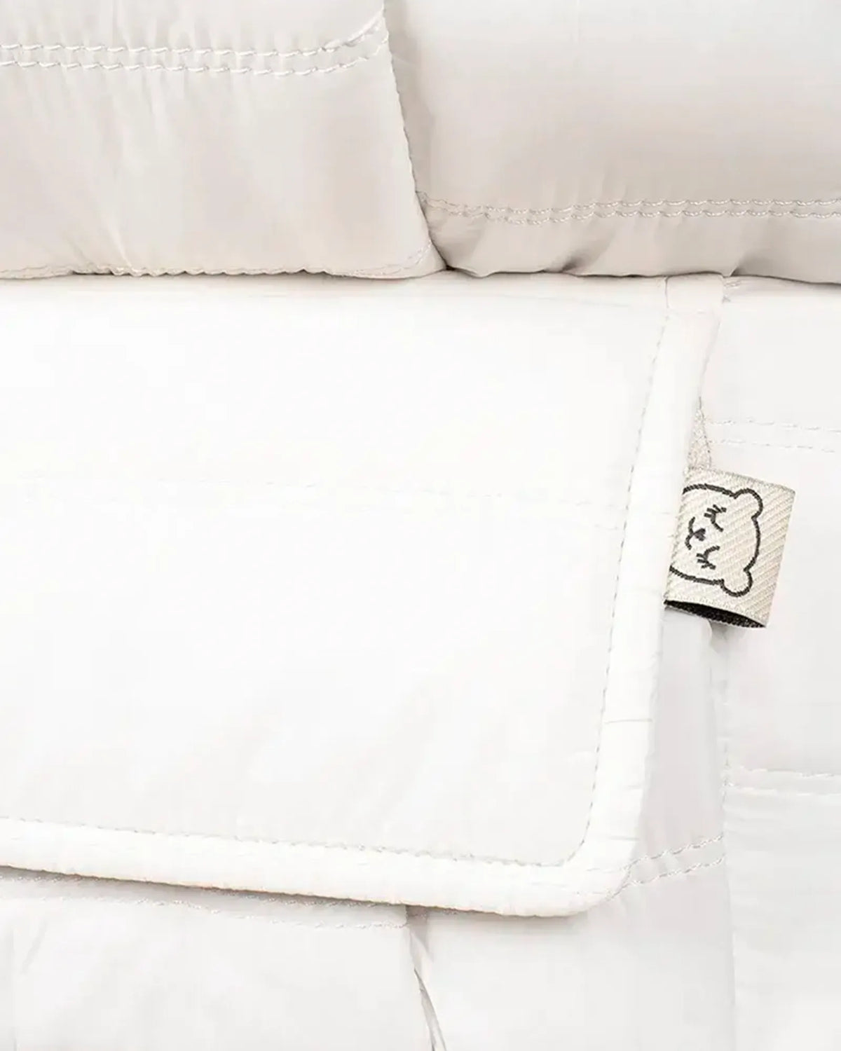 Close up of the Tula Explore Puffer White baby carrier