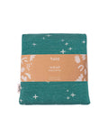 A folded Tula baby wrap in teal green with a white star and footprint pattern.